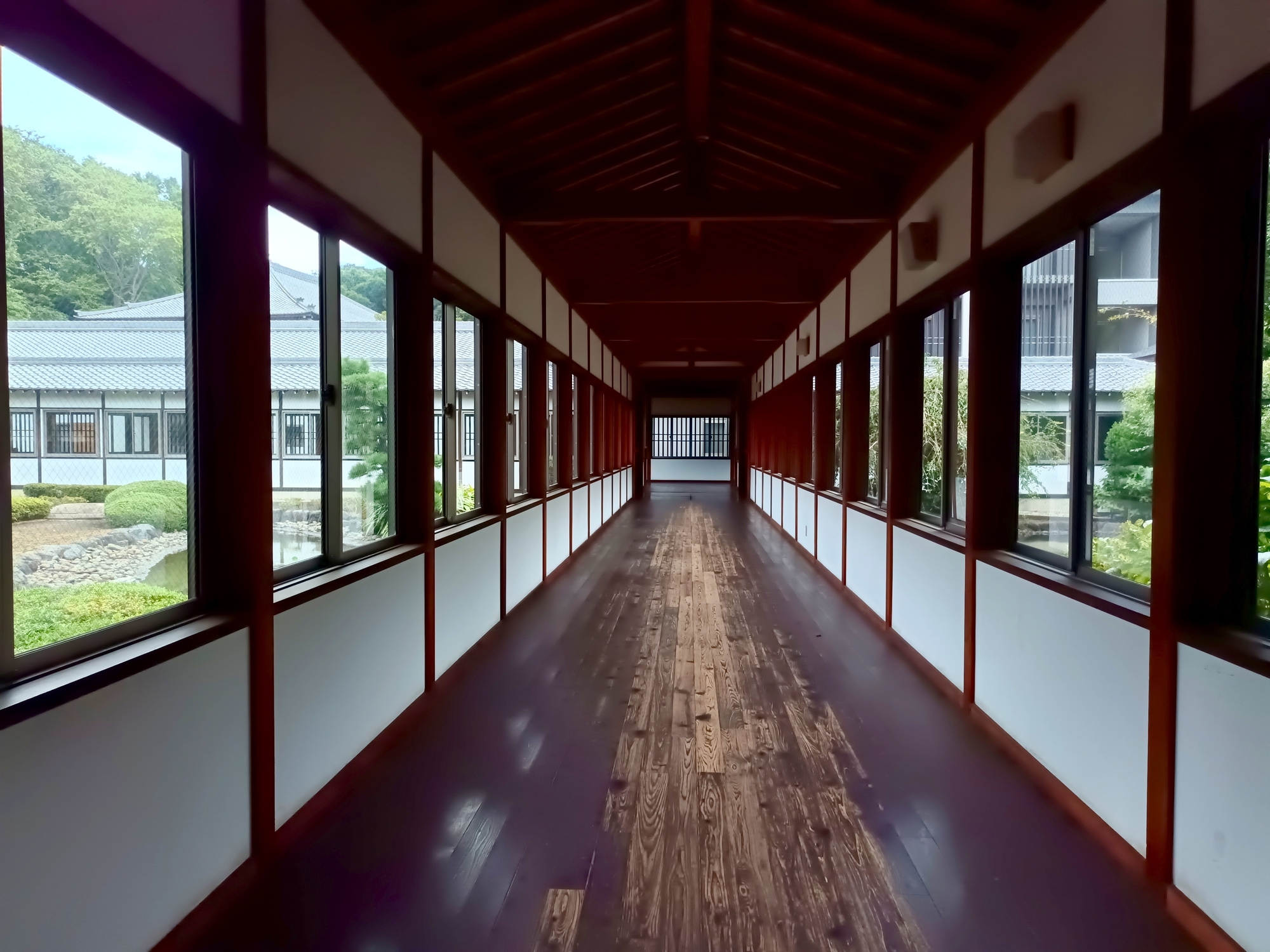 總持寺の百間廊下。磨かれた板張りの床が奥まで一直線に続き、右手に窓が並ぶ